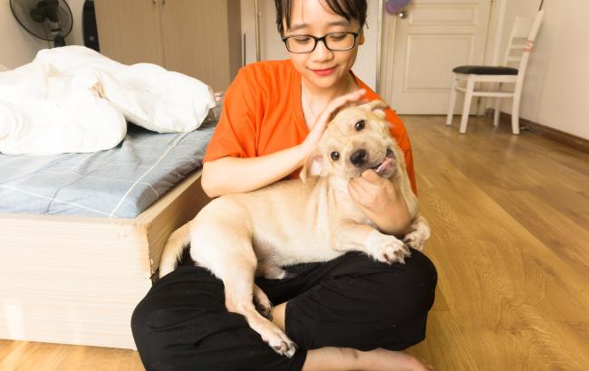Woman cuddling dog